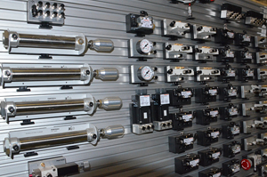 This is a pneumatics system. Pneumatics refers to the science or devices related to the movement and phenomena of air. An air compressor converts the mechanical energy of the prime mover into, mainly, pressure energy of the compressed air. The compressed air is stored in compressed air reservoirs and transmitted through transmission lines: pipes and hoses. The pneumatic power is controlled by means of a set of valves such as the pressure, flow, and directional control valves. Then, the pressure energy is converted to the required mechanical energy by means of the pneumatic cylinders and motors.